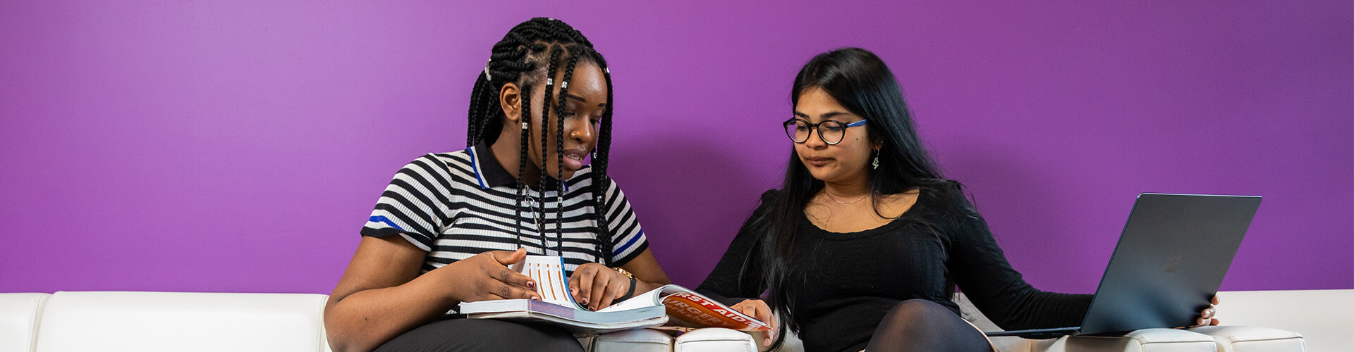 Students looking at book